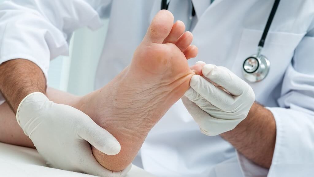 one of our Podiatry & Chiropody looking at an foot